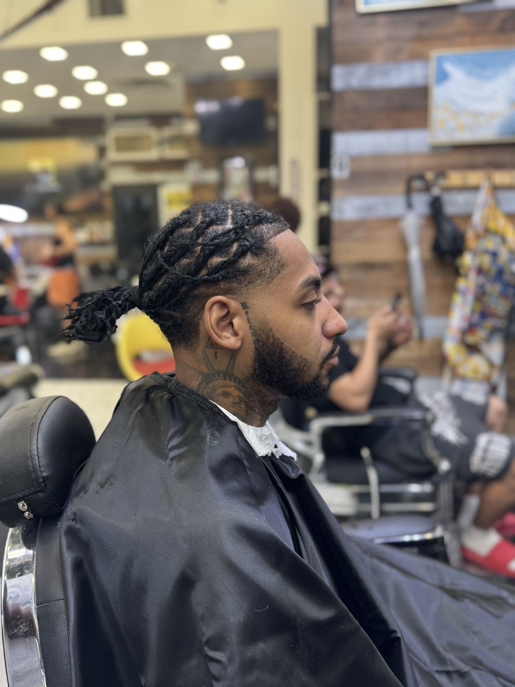 Barber at work at Blade Barbershop, 1336 St Nicholas Ave